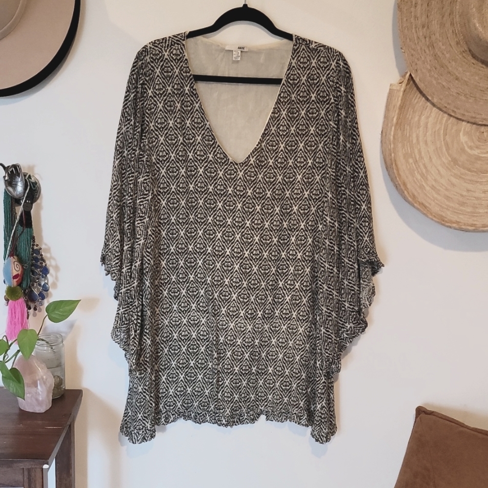 A diamond patterned black and white swing dress with bell sleeves in size Large